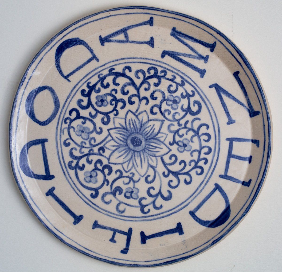 A blue and white plate that says