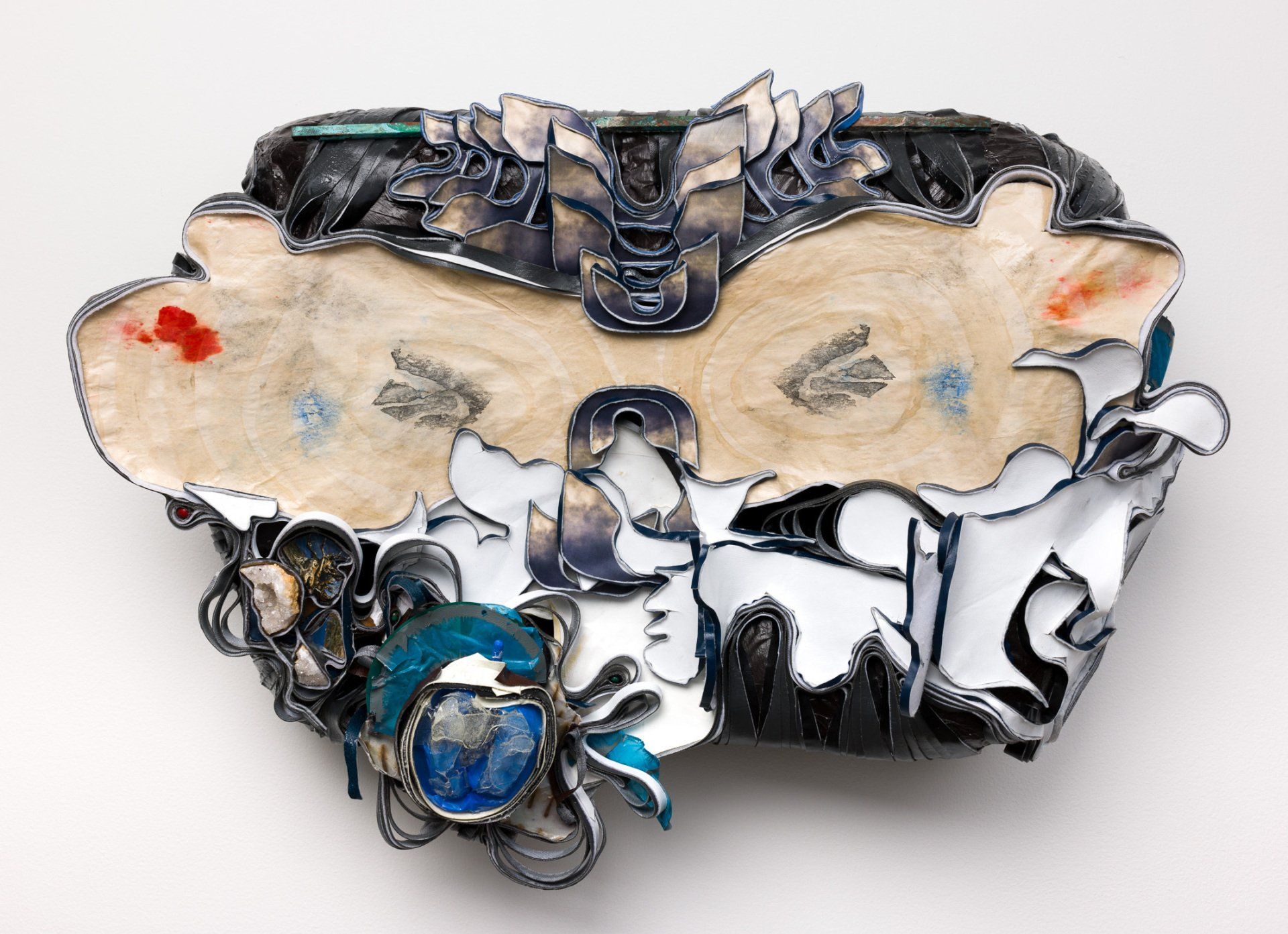 A piece of art that looks like a butterfly is on a white surface