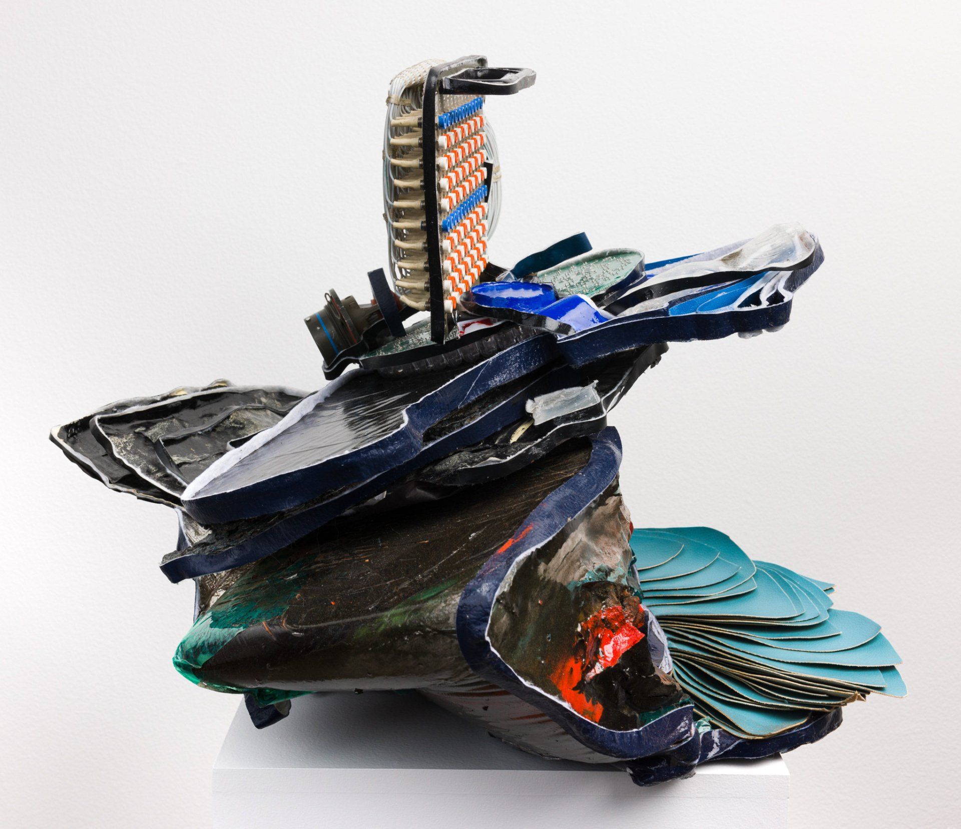 A sculpture of a boat is sitting on a white surface