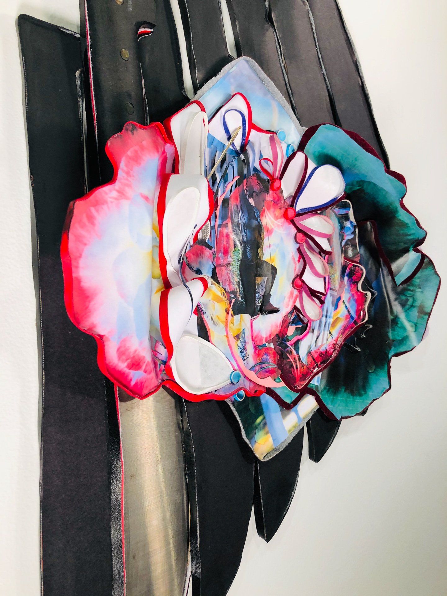 A close up of a colorful flower on a black belt