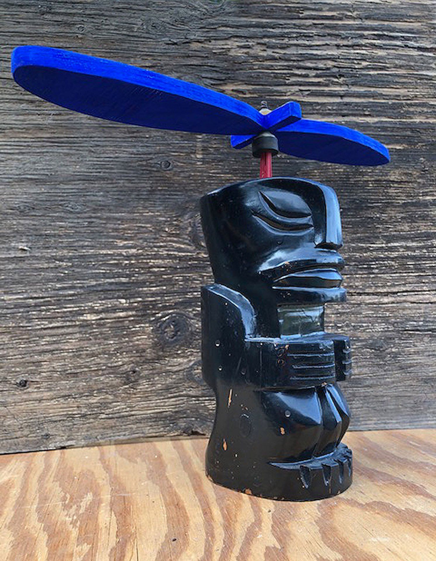 A statue with a blue propeller on top of it