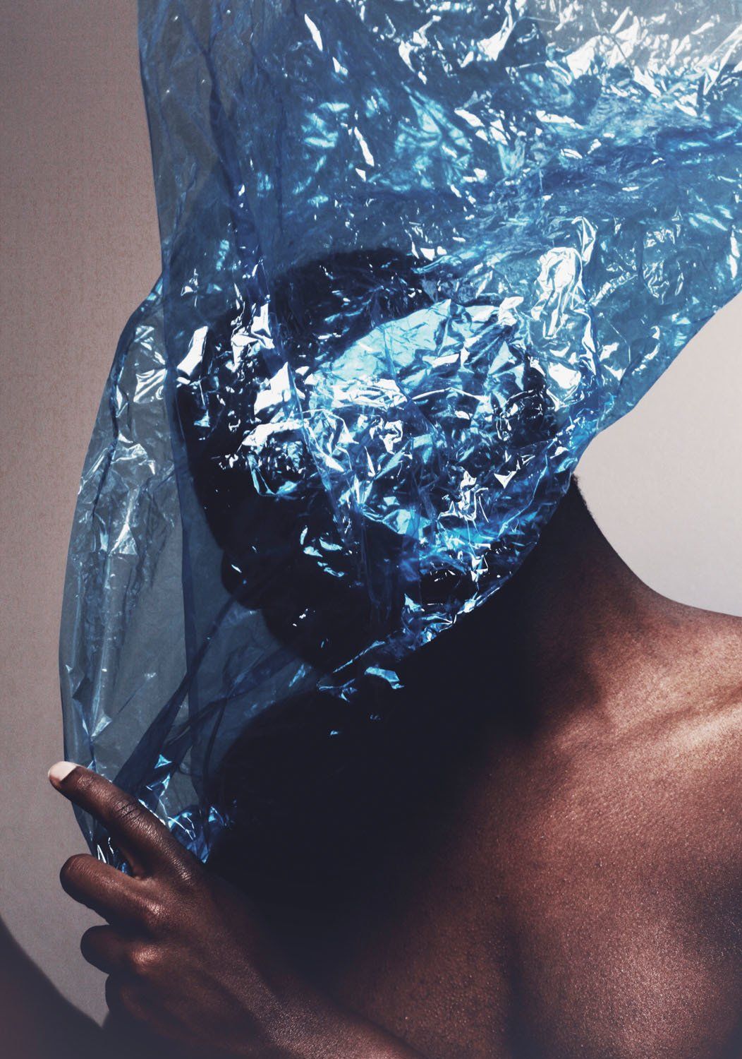 A person with a blue plastic bag over their head