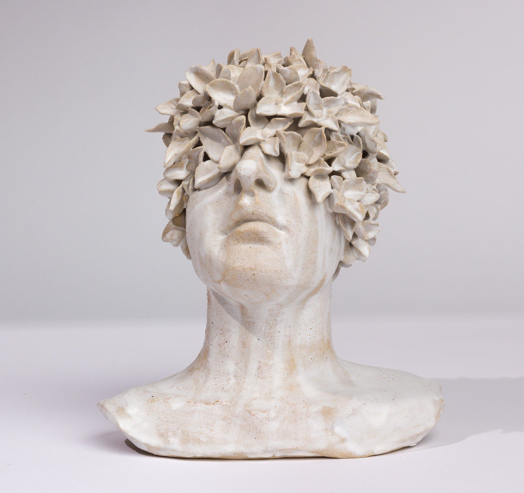 A statue of a man with flowers on his head