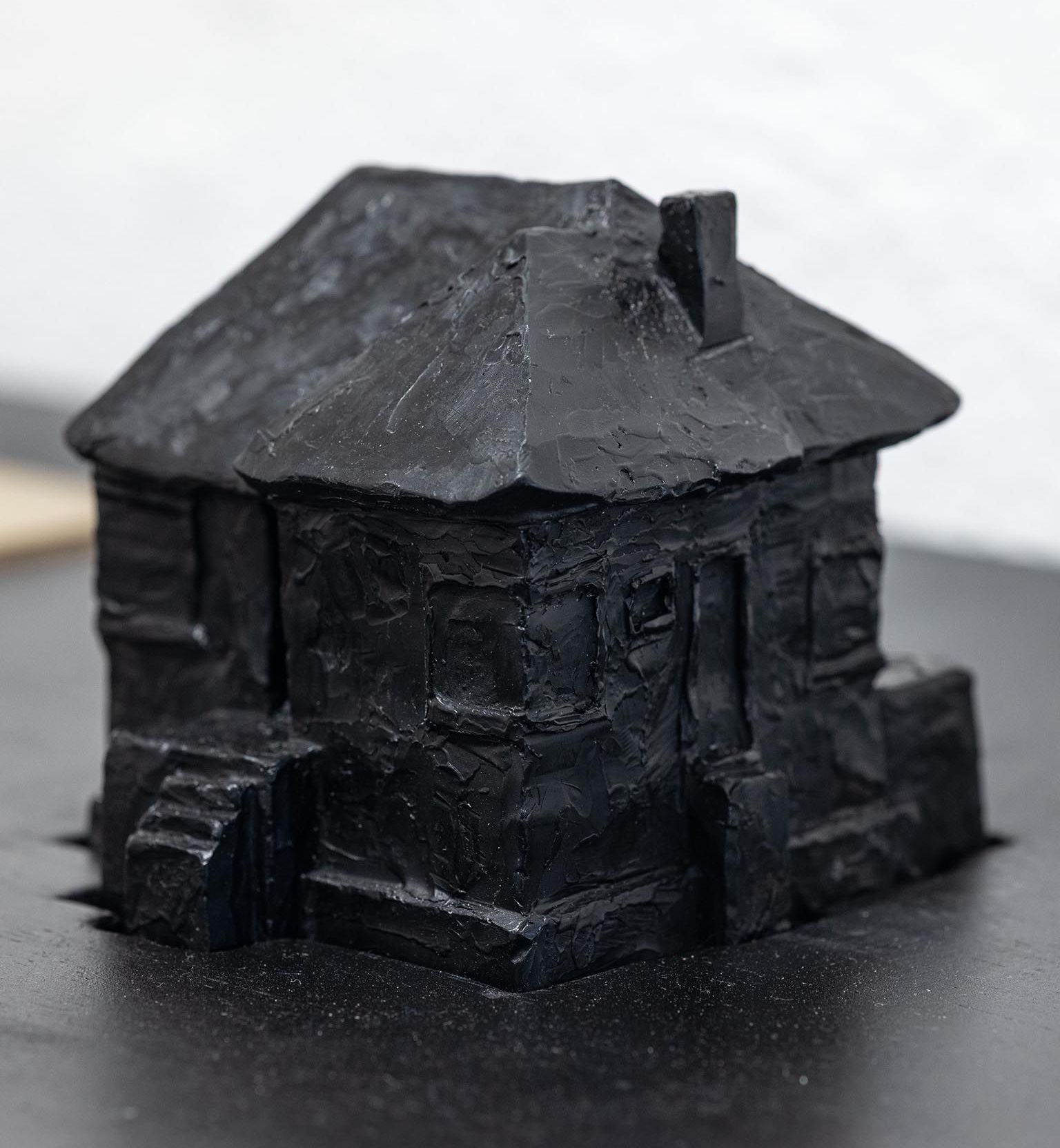 A painting with the head of a sleeping woman and a floating eye  in the center surrounded by a circle of flower bud shapes and a circle of eyes.