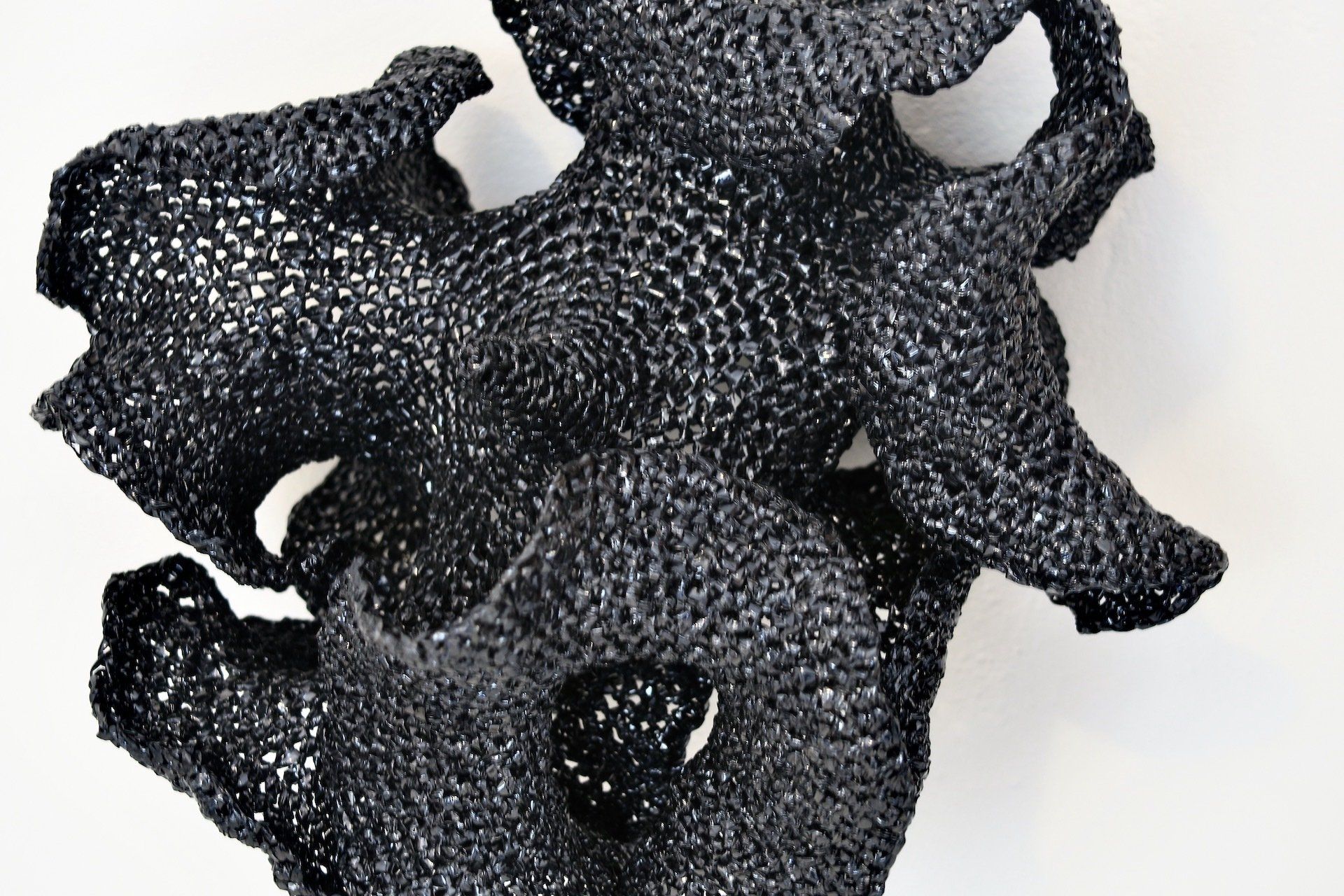 A close up of a black object on a white surface