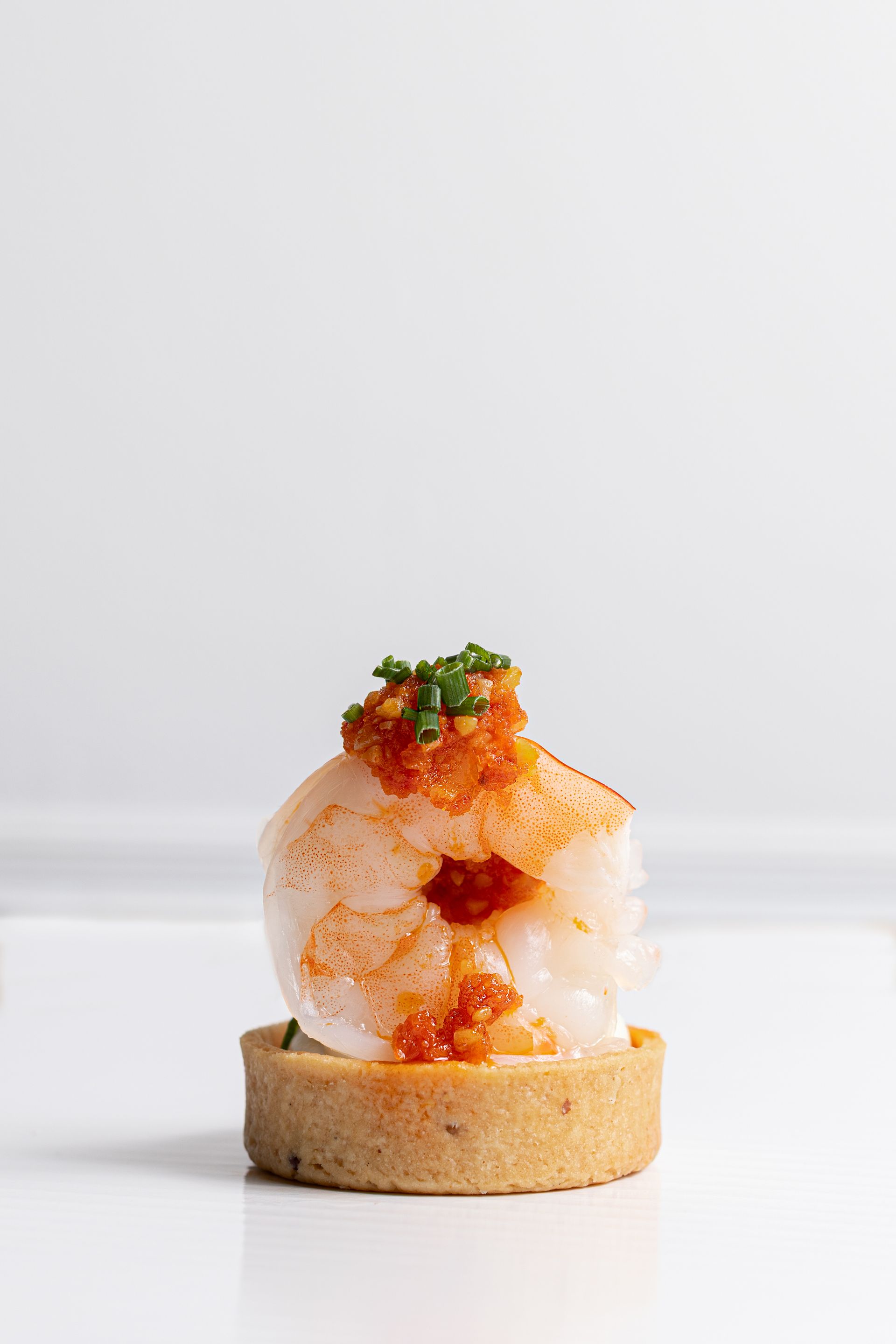 A close up of a shrimp appetizer on a white plate.