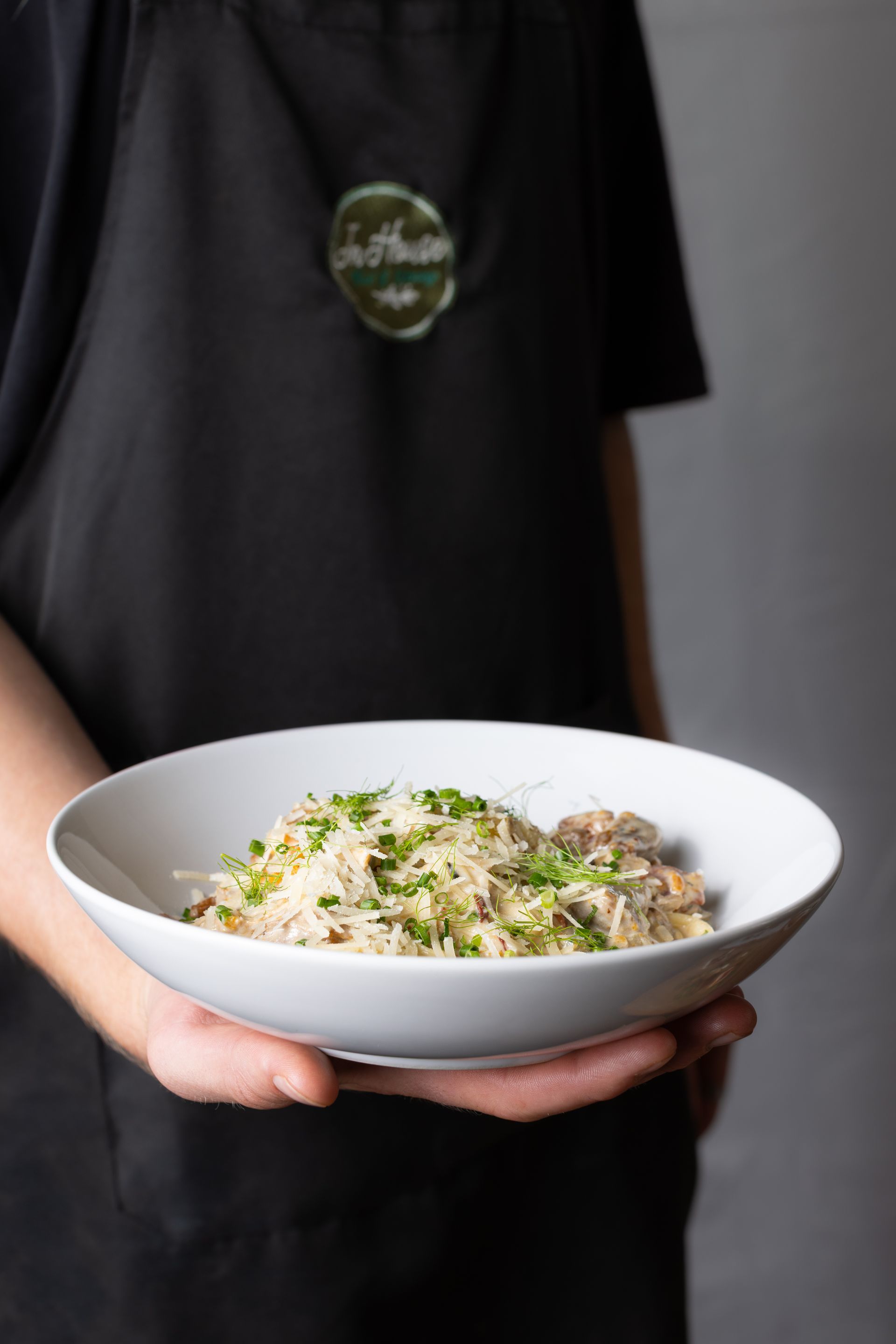 A person is holding a bowl of food in their hands.