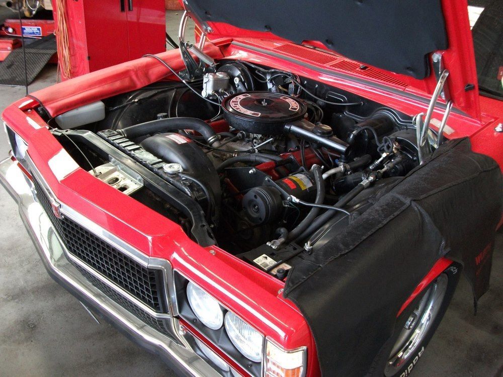 A Red Car With The Hood Up And The Engine Visible — Gympie Diesel & Dyno Centre in Glanmire, QLD