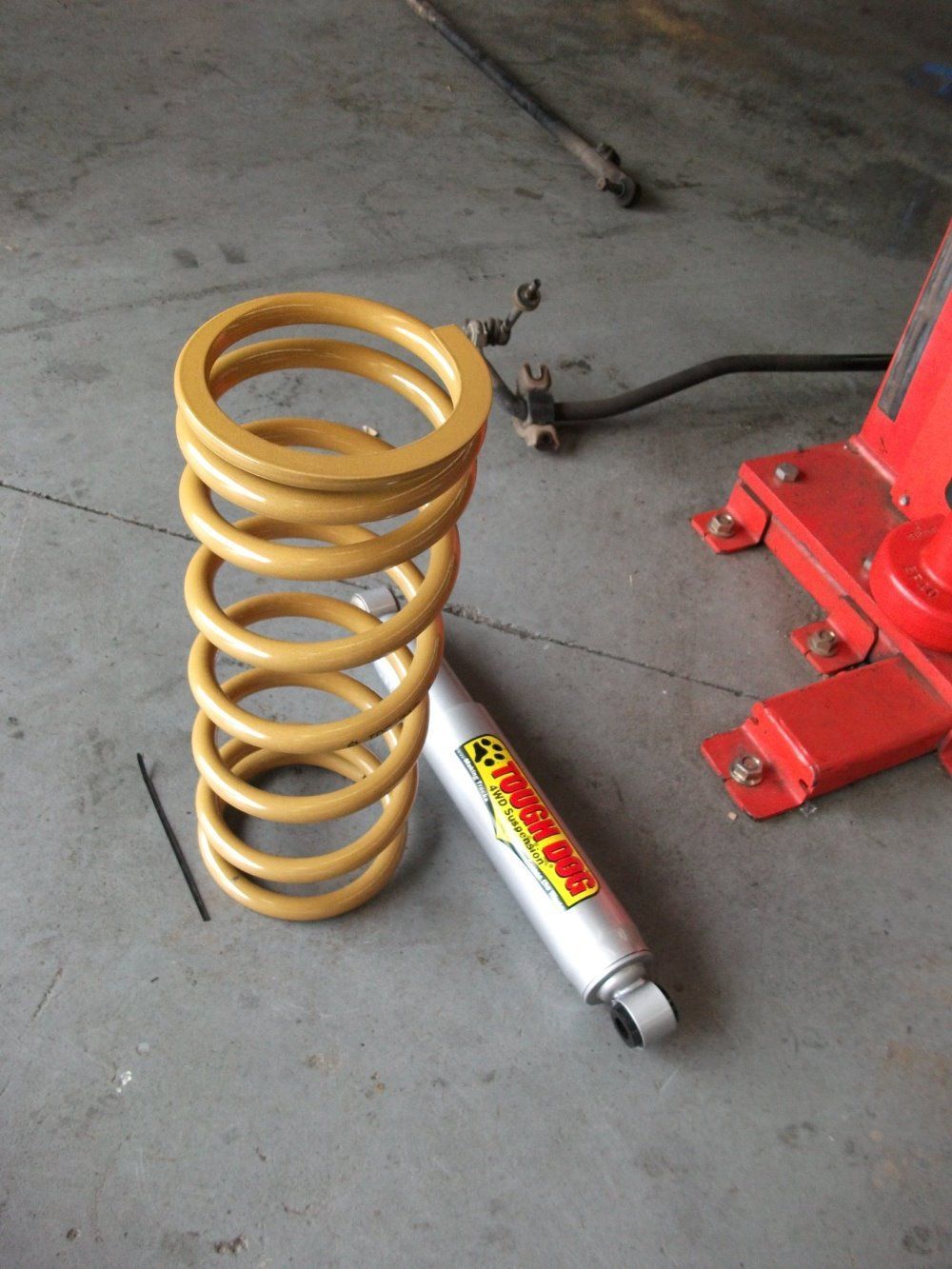 A Coil Spring Next To A Shock Absorber That Says Shockwave — Gympie Diesel & Dyno Centre in Glanmire, QLD