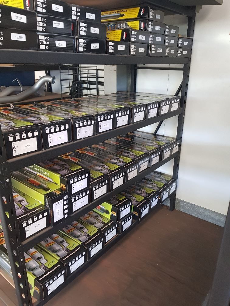 A Warehouse Filled With Lots Of Boxes And Shelves — Gympie Diesel & Dyno Centre in Glanmire, QLD