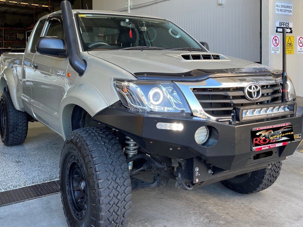 A Toyota Hilux Truck Is Parked In Front Of A Building — Gympie Diesel & Dyno Centre in Glanmire, QLD