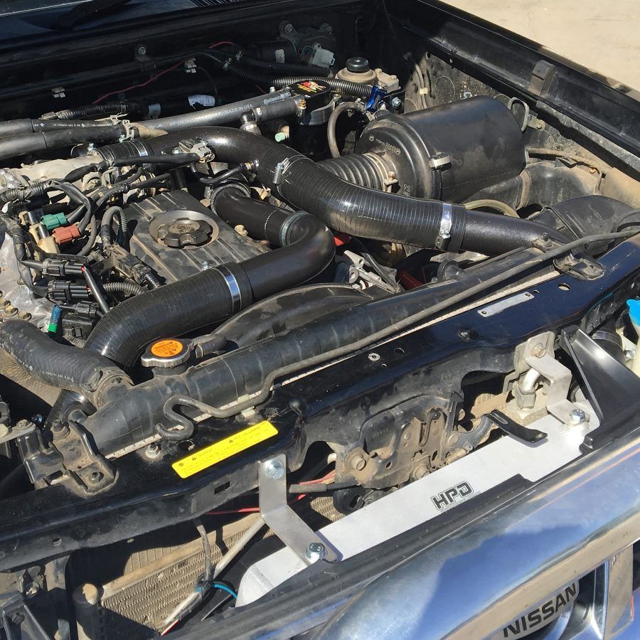 A Man Is Working On A Car Engine With A Wrench — Gympie Diesel & Dyno Centre in Glanmire, QLD