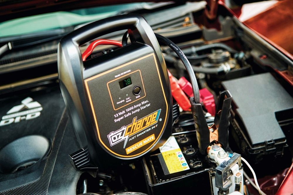 A Jump Starter Is Sitting Under The Hood Of A Car — Gympie Diesel & Dyno Centre in Glanmire, QLD