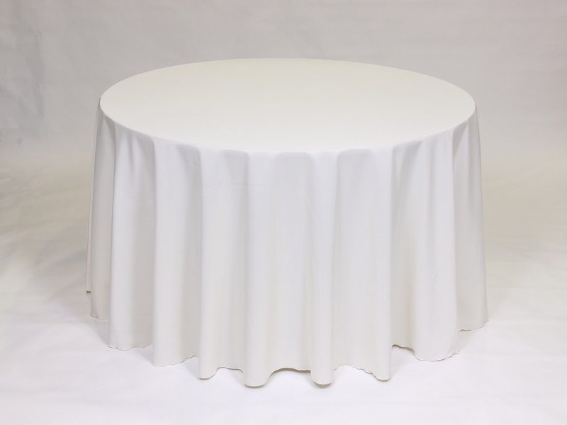 A round table with a white tablecloth on it.