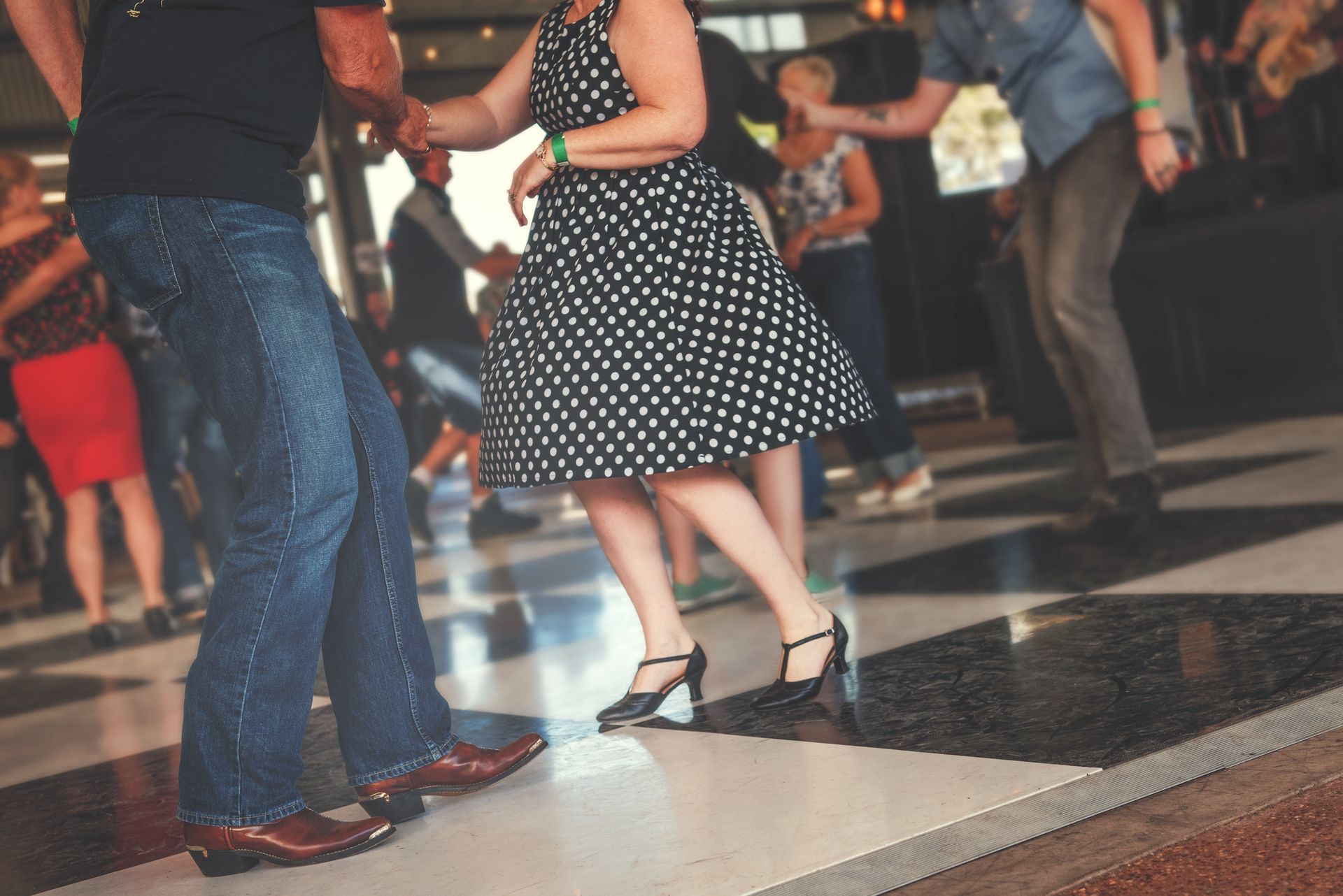 A group of people are dancing on a dance floor.