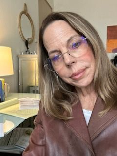 Woman wearing glasses and a brown coat