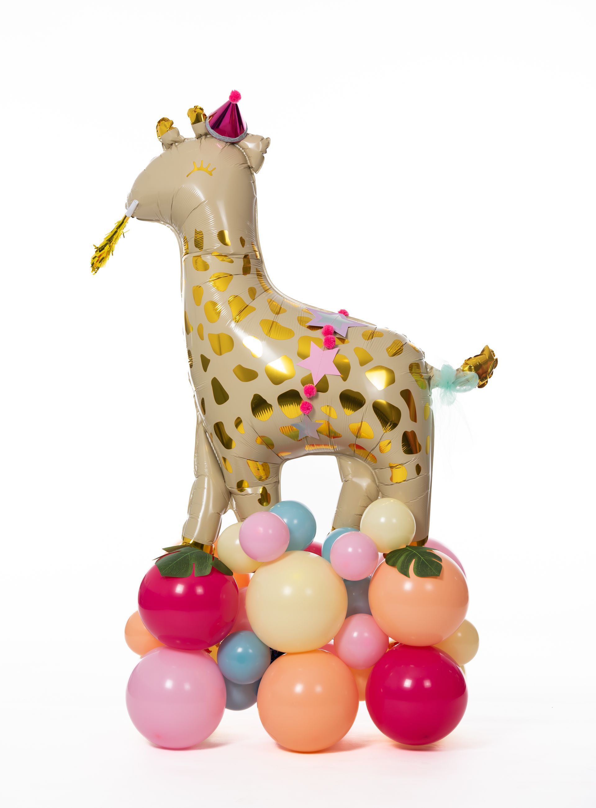 A giraffe balloon is sitting on top of a pile of balloons.