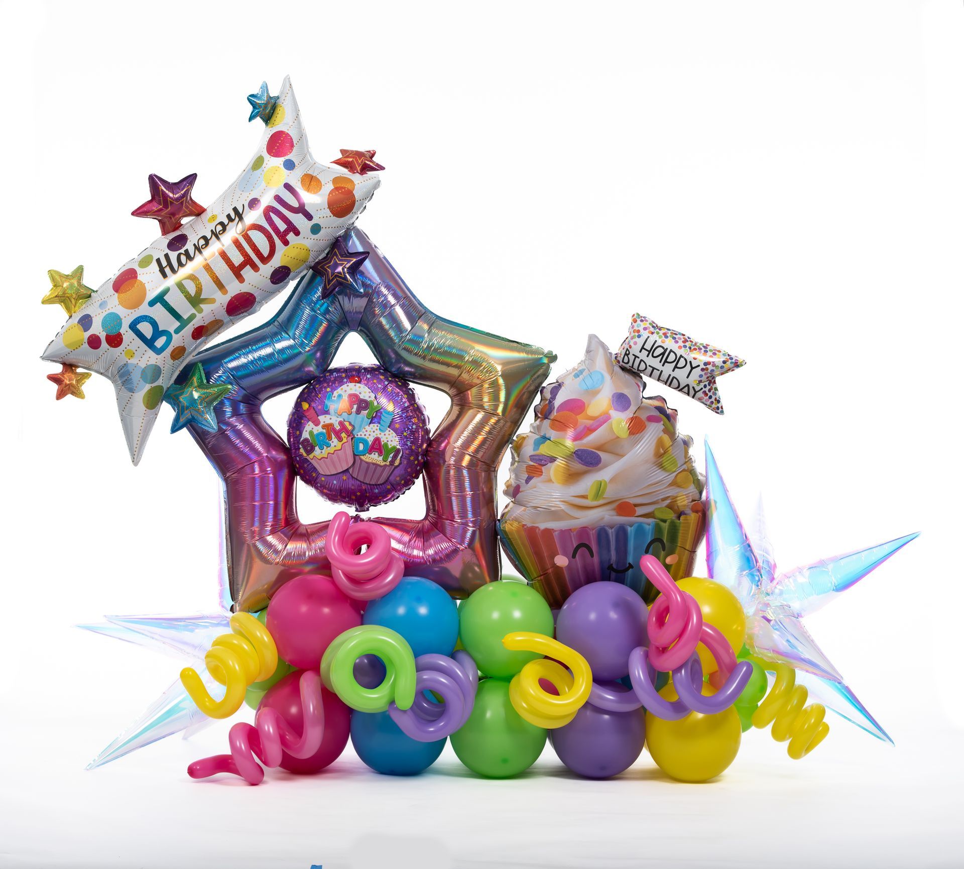 A bunch of colorful balloons are sitting on top of each other on a table.