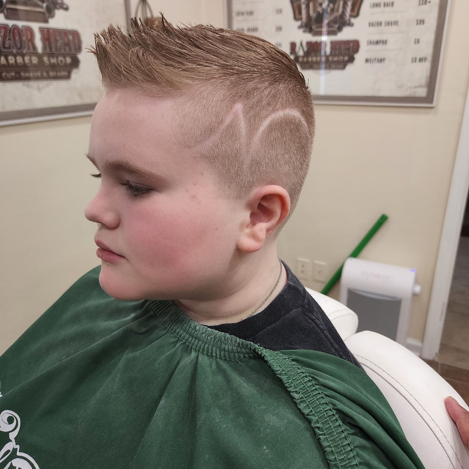 A person with a short, textured haircut featuring an 