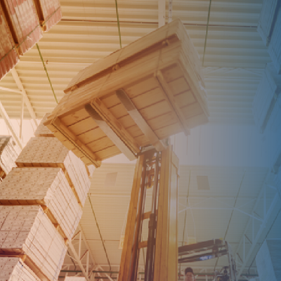 Warehouse forklift lifting stacked pallets toward the ceiling