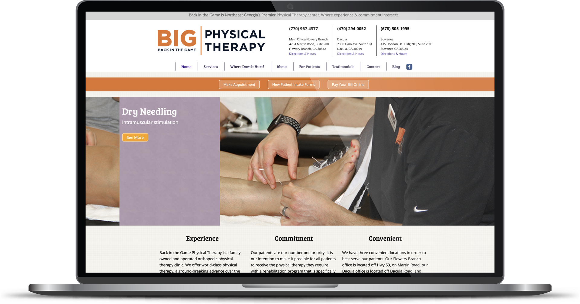 Laptop displaying Big Physical Therapy website with therapist treating a patient