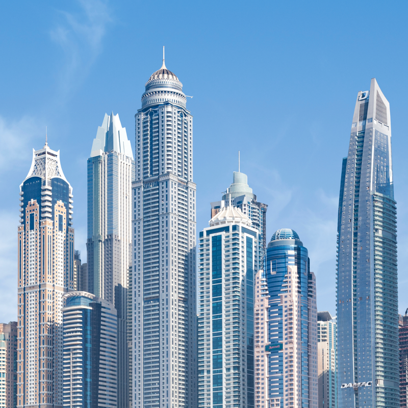 Modern skyscrapers and high-rise towers against a clear blue sky in a city skyline