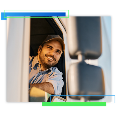 Smiling truck driver leaning out of a cab window with arms crossed