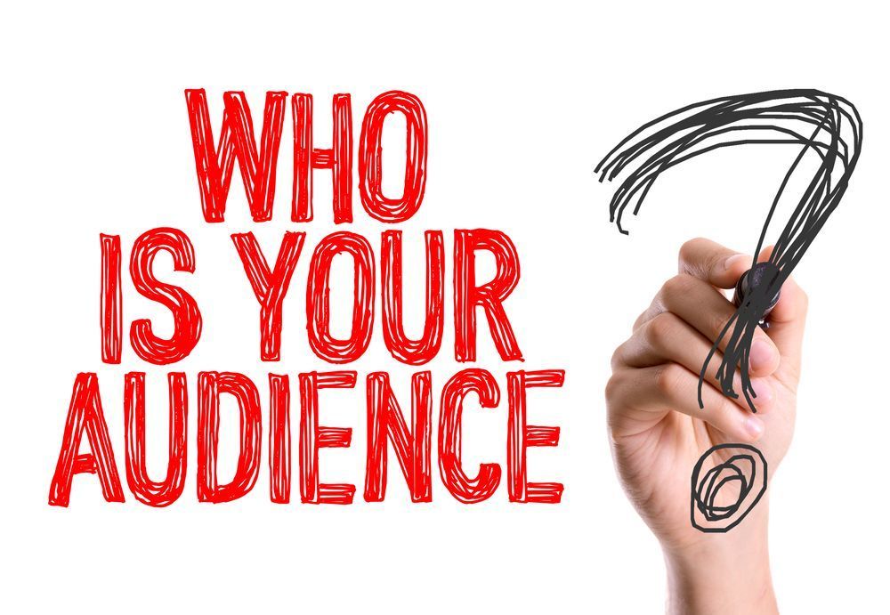Hand writing a question mark beside red text reading “WHO IS YOUR AUDIENCE”