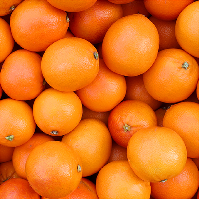 A pile of bright orange oranges filling the frame