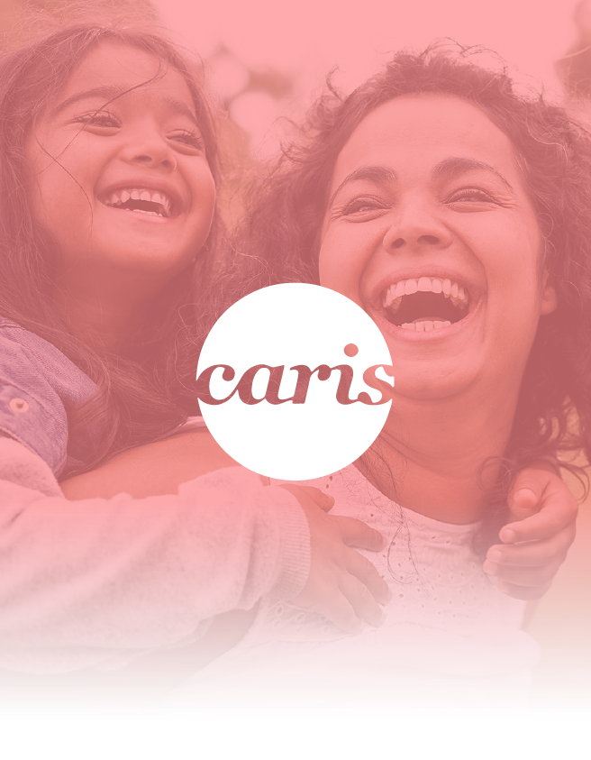 Two smiling people in a pink-tinted photo with the word “caris” centered in a white circle