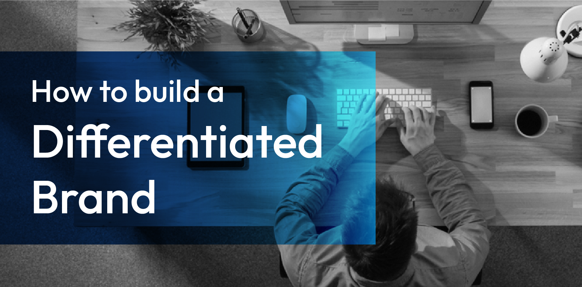 How to build a differentiated brand over a blue overlay on a grayscale workspace scene