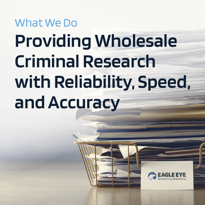 Wholesaler research service ad with stacked case files and Eagle Eye logo on a desk