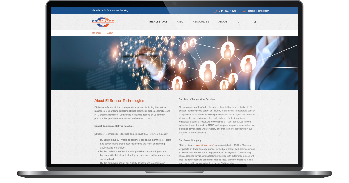 Laptop displaying a website homepage with a blue header, glowing lights graphic, and text sections below