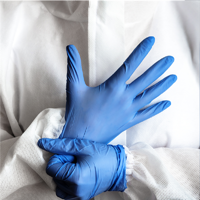 Blue gloved hands adjusting a cuff on a white lab coat
