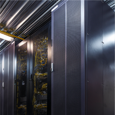 Data center server racks with black cabinets, mesh doors, and visible yellow cabling under overhead lights
