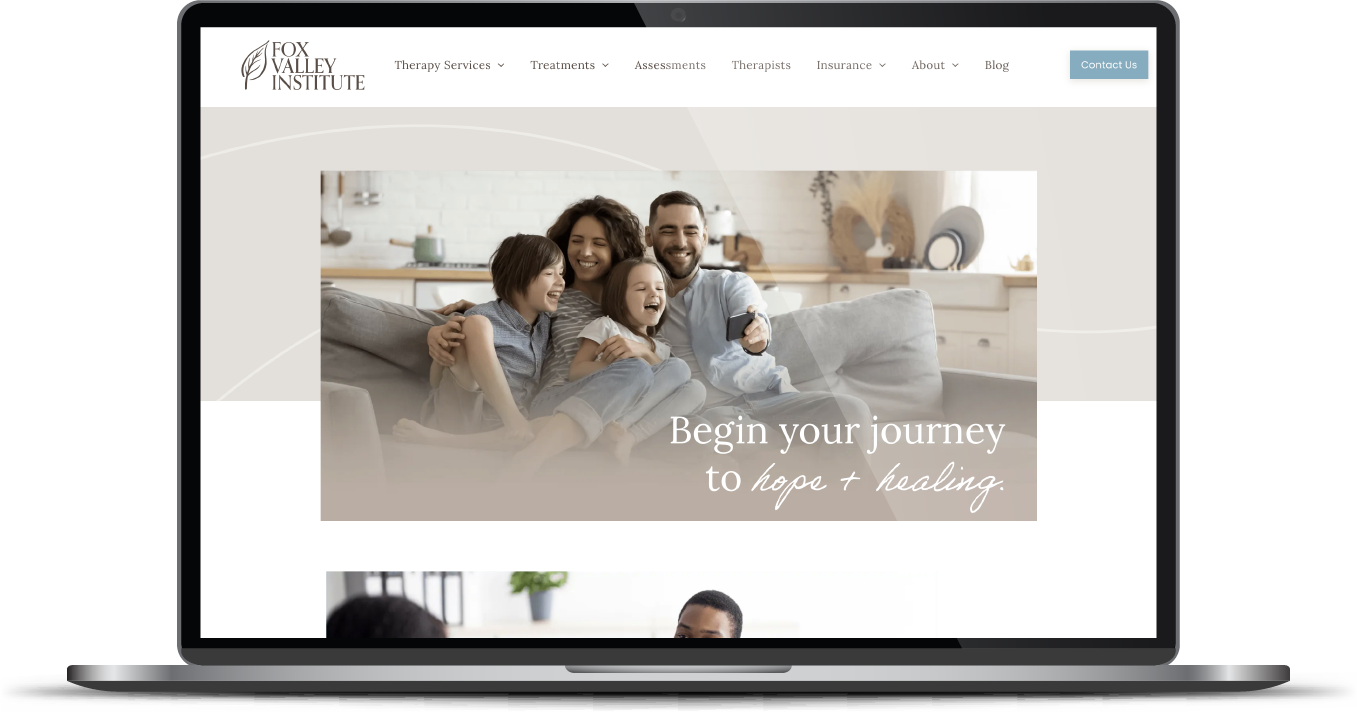 Laptop displaying a family website homepage with a hero banner of a smiling couple and child