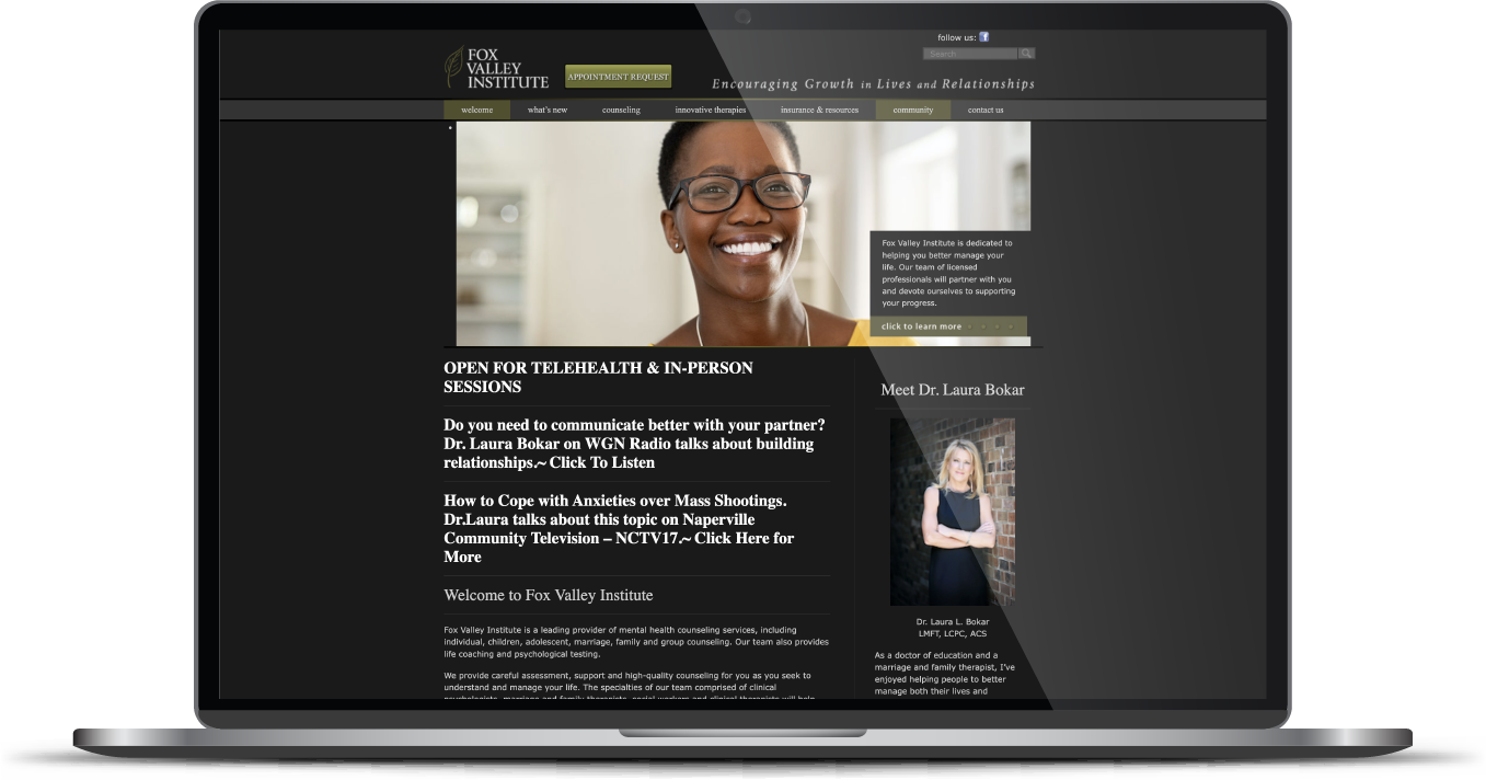 Laptop displaying a dark-themed webpage with a smiling person’s photo and text blocks on the screen