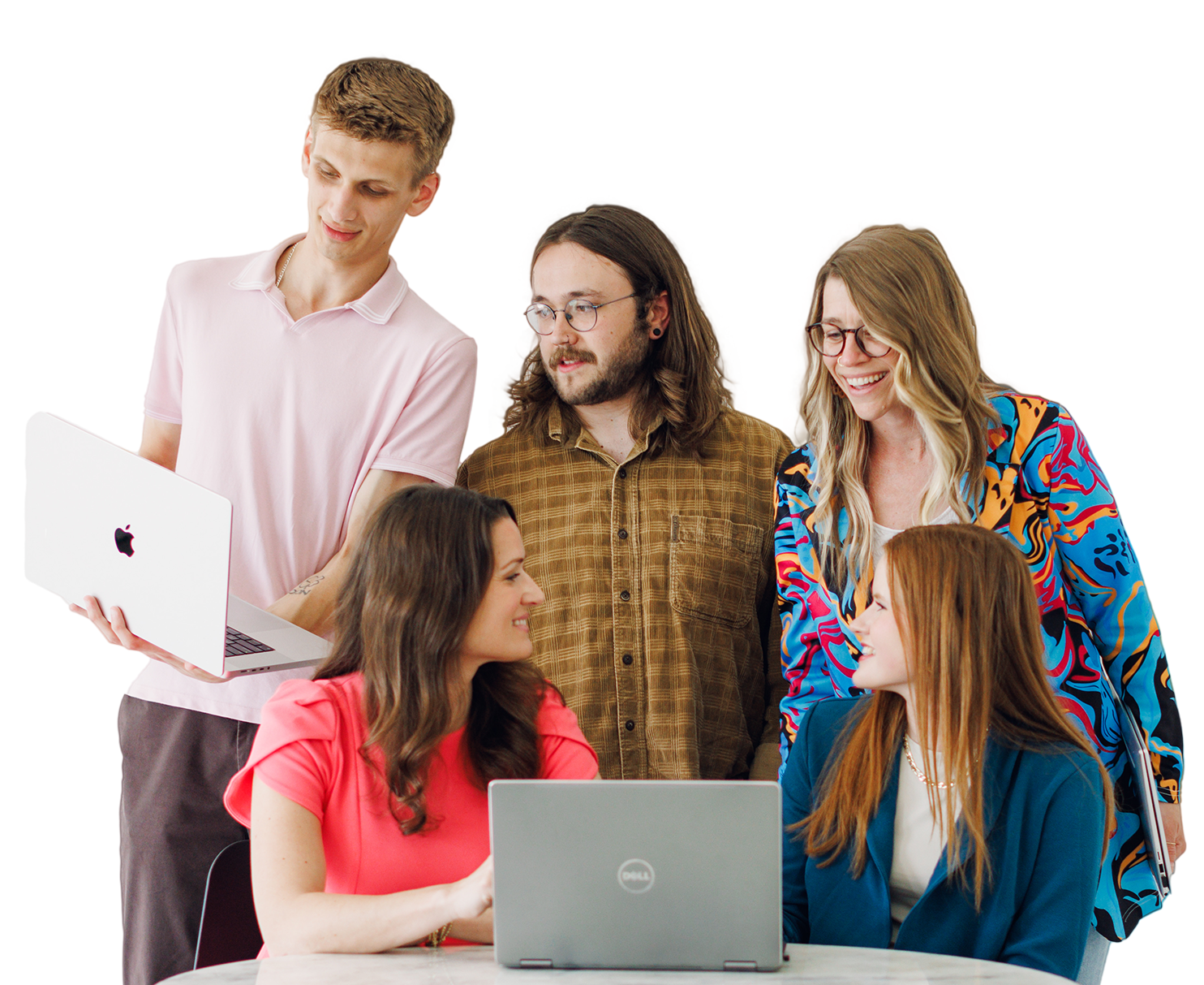 Five people gathered around laptops, collaborating in a bright office setting.