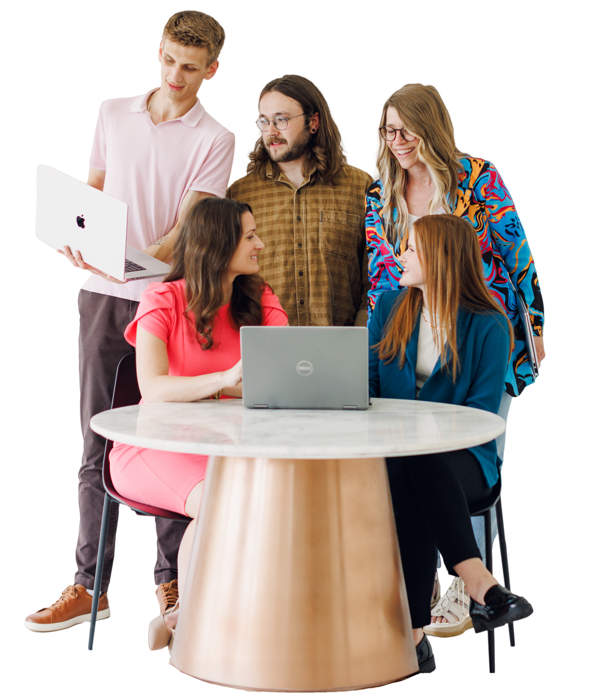 Five people gathered around a round table with laptops, collaborating in a bright studio.