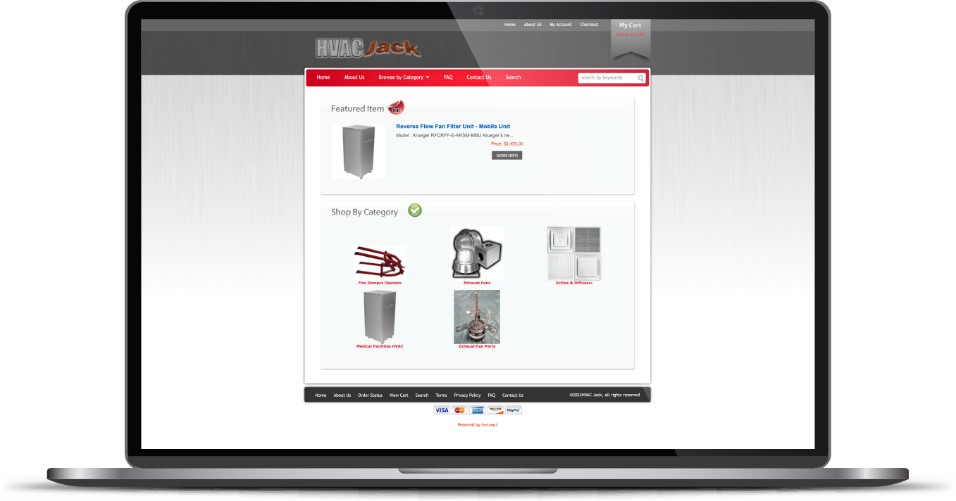 Laptop displaying a shopping website with product thumbnails and a red header