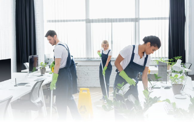 Office cleaning crew mopping and wiping desks in a bright modern workspace