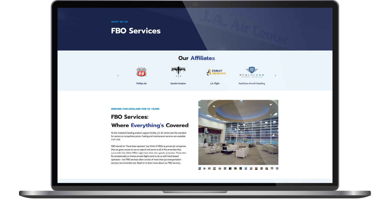 Laptop displaying a website homepage with a blue header, icons, text, and a conference room photo.