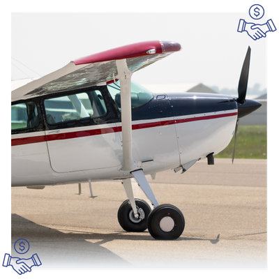 White single-engine propeller airplane with red stripe parked on a runway.