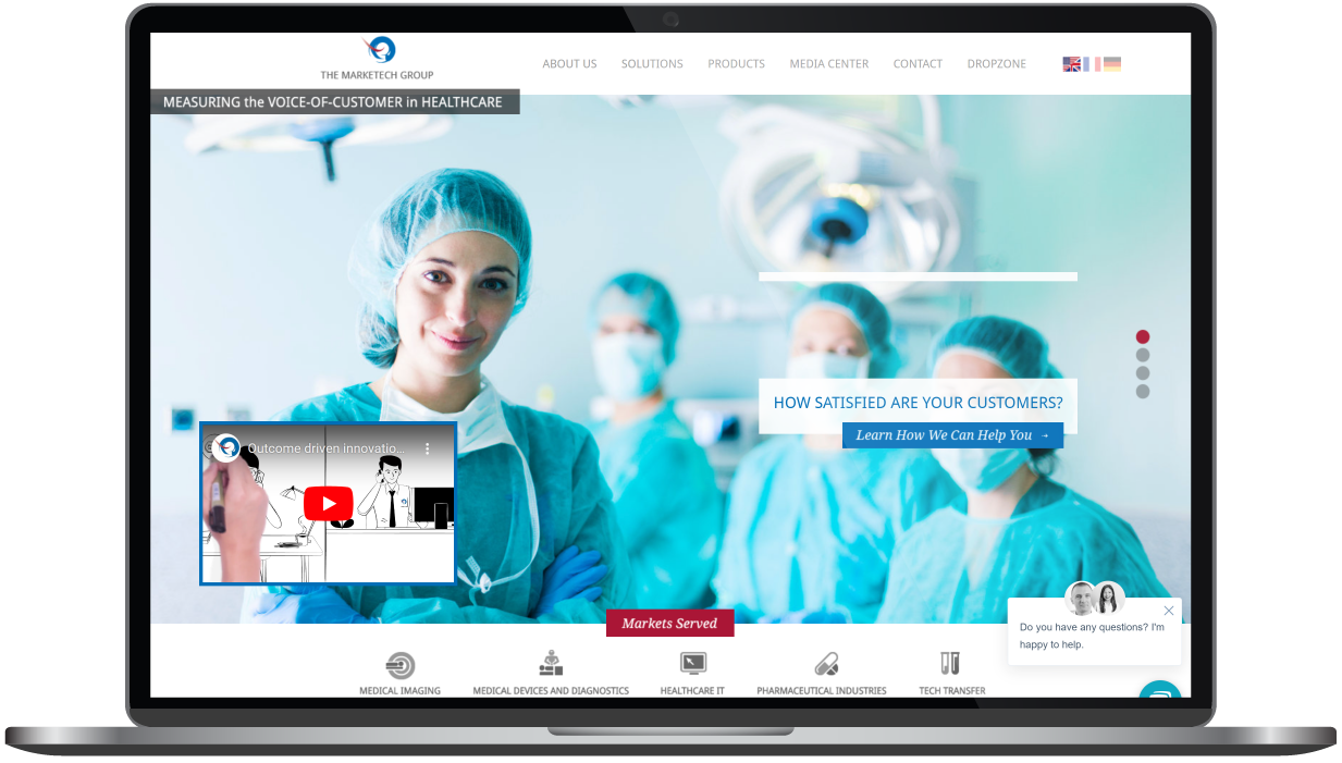 Hospital website shown on a laptop screen with surgeons in blue scrubs in the background