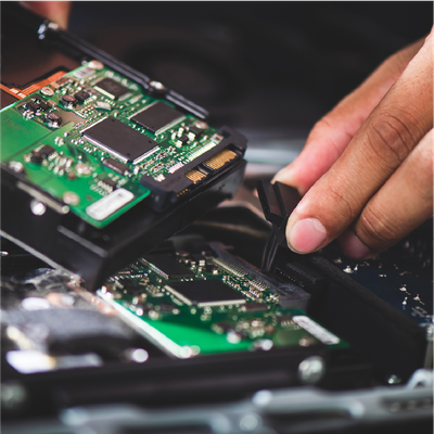 Hands repairing exposed smartphone circuit boards with tweezers and tools