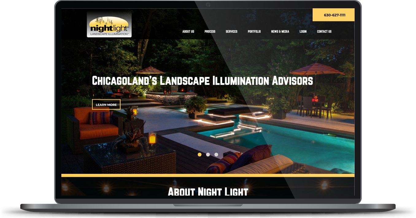 Website homepage on a laptop screen showing landscape illumination services over a lit pool at night