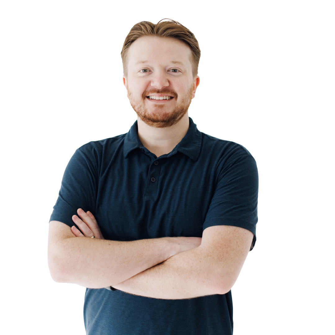 Smiling person in a navy polo shirt with arms crossed on a white background