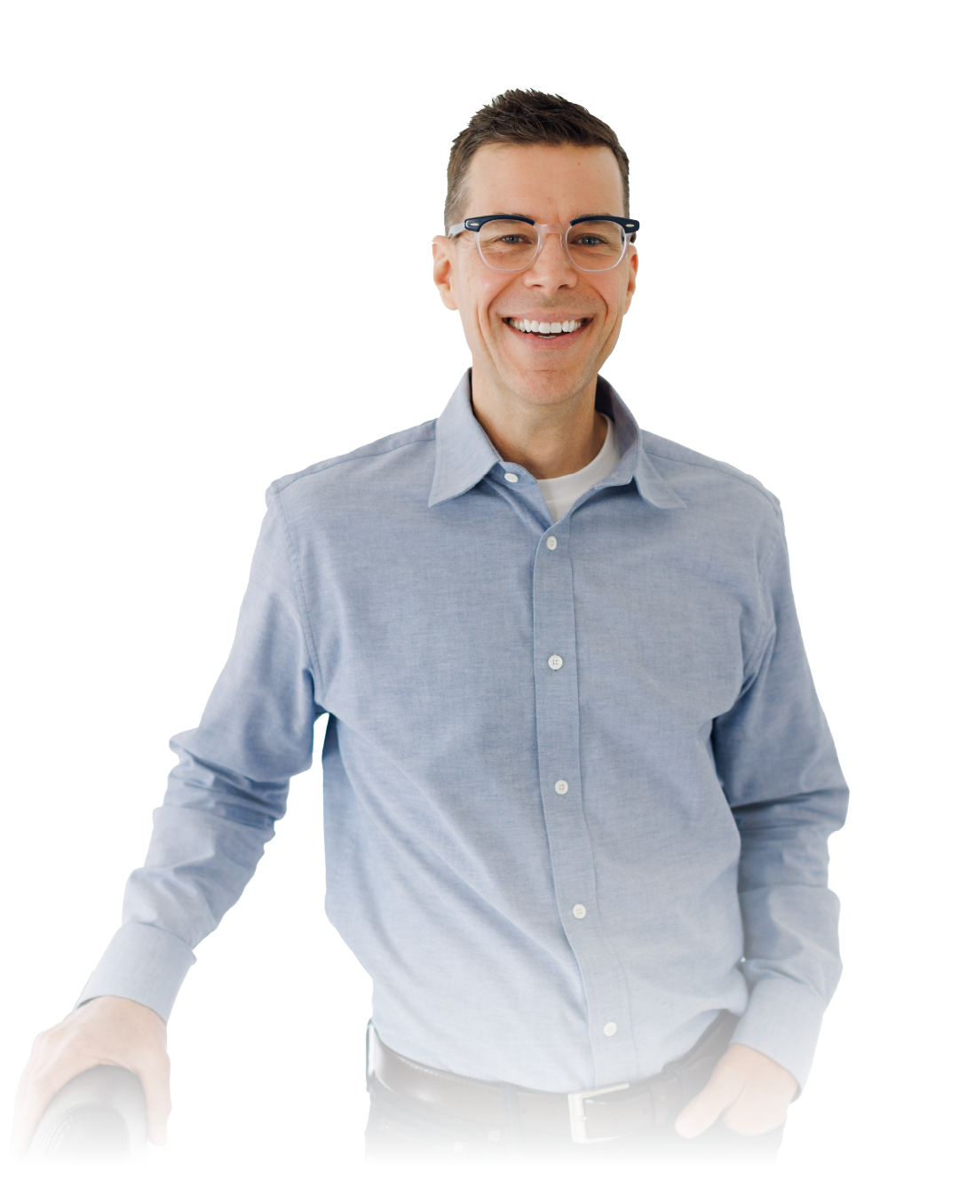 Smiling person in glasses wearing a light blue button-up shirt against a white background