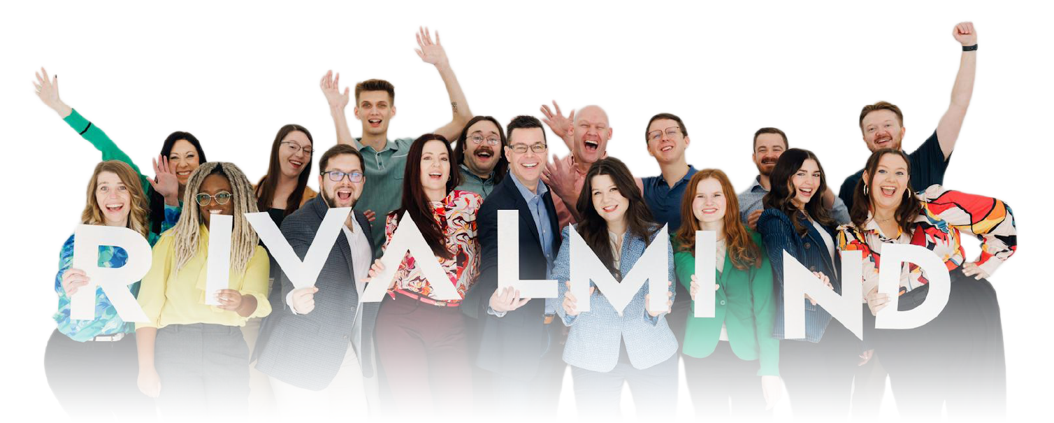 Group of smiling people standing behind large white letters spelling “RHYTHMIND”