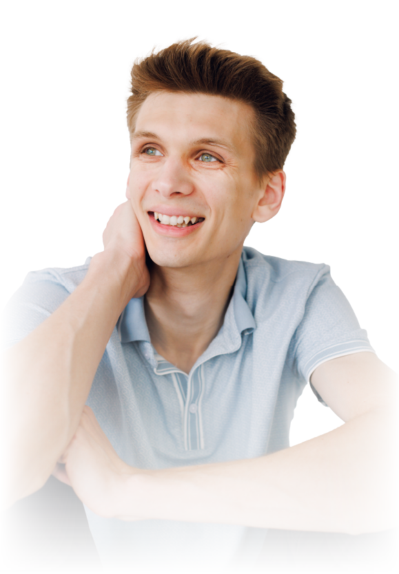 Smiling man in a light blue shirt looking upward and resting his hand on his neck